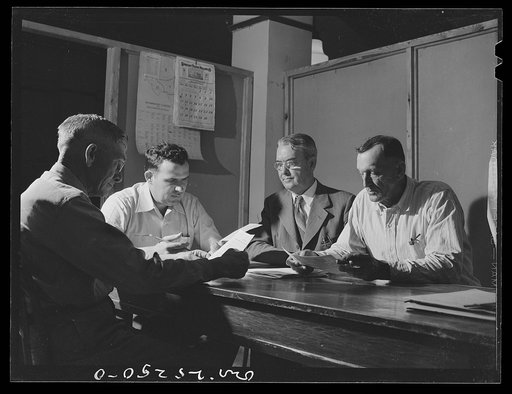 San Augustine, Texas. The rationing board in session. Left to right: Mr. Long, retired rural mail carrier; Mr. Curl, banker; Mr. Wood, clothing store owner; Mr. Brown, AAA (Agricultural Adjustment Administration) supervisor