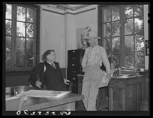 San Augustine, Texas. Judge Robert Norvell talking with W.F. Hayes, editor of the San Augustine Tribune