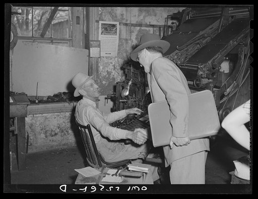 San Augustine, Texas. Mr. Hays, editor of the San Augustine Tribune, shaking hands with a salesman