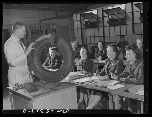 Untitled photo, possibly related to: Holabird ordnance depot, Baltimore, Maryland. A group of WAACS (Women's Auxiliary Army Coprs) receive instruction in tire structure and care as part of the automotive preventive maintenance course which all Army men and women at Holabird must take. Instructor is 