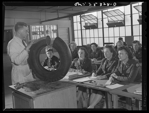 Untitled photo, possibly related to: Holabird ordnance depot, Baltimore, Maryland. A group of WAACS (Women's Auxiliary Army Coprs) receive instruction in tire structure and care as part of the automotive preventive maintenance course which all Army men and women at Holabird must take. Instructor is 