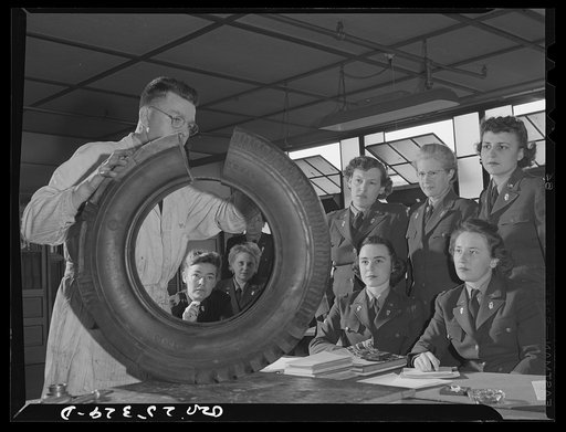 Untitled photo, possibly related to: Holabird ordnance depot, Baltimore, Maryland. A group of WAACS (Women's Auxiliary Army Coprs) receive instruction in tire structure and care as part of the automotive preventive maintenance course which all Army men and women at Holabird must take. Instructor is 