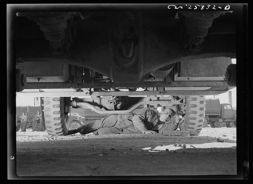 Holabird ordnance depot, Baltimore, Maryland. Periodic complete vehicle inspection is required of all United States Army drivers. This soldier is checking the wheel alignment of his truck, an important factor in the length of life of tires