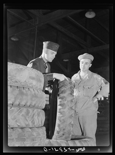 Holabird ordnance depot, Baltimore, Maryland. Lieutenant George Sundstrom, San Bernardino, California, and Staff Sergeant Harold Creasap, Akron, Ohio, inspecting an Army truck tire which has been brought to the recapping shop. All tires are given this preliminary visual inspection