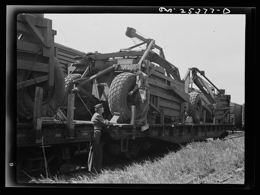 Holabird ordnance depot, Baltimore, Maryland. Careful records of air pressure in a Le-Tourneau roadscraper's giant tires are made before the scrapers are shipped overseas. Ten pounds additional pressure is put in tires before the journey to assure best condition of the tire upon arrival