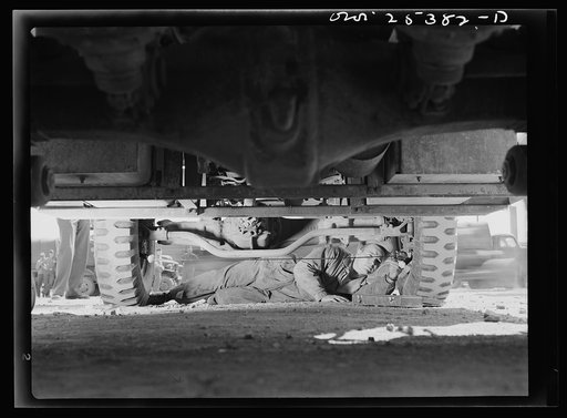 Holabird ordnance depot, Baltimore, Maryland. Periodic complete vehicle inspection is required of every United States Army driver. This soldier is checking the wheel alignment of his truck, one of the most important factors in the length of life of tires