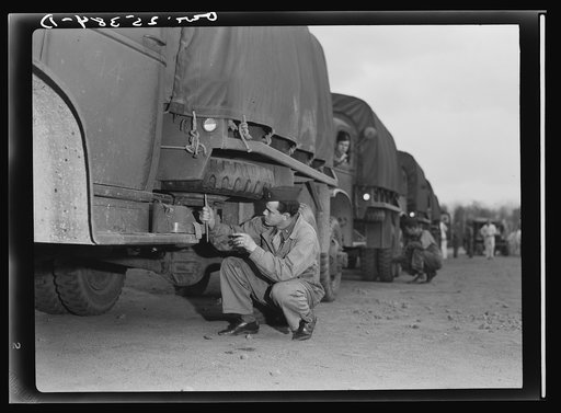 Holabird ordnance depot, Baltimore, Maryland.  A soldier checking the air pressure on his spare tire. The gages are called "fiddlesticks"