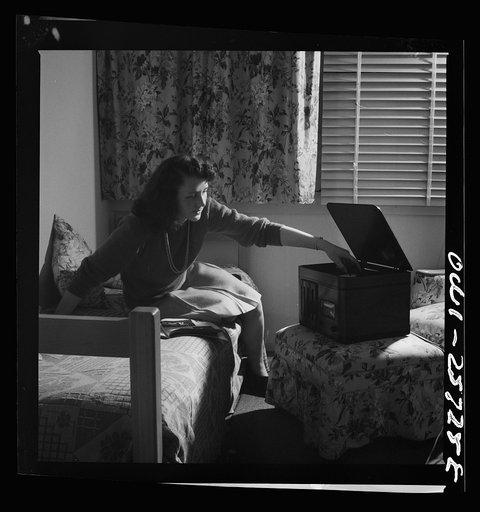 Arlington, Virginia. A girl in her room playing a phonograph at Arlington Farms, a residence for women who work in the government for the duration of the war