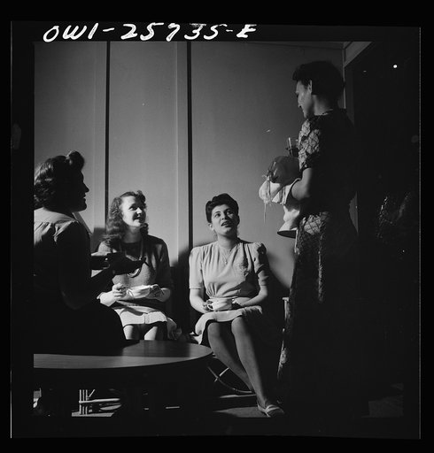 Arlington, Virginia. Girl on her way to the laundry room stops in one of the small alcoves to talk to some of her girlfriends, in a residence for women who work for the government for the duration of the war