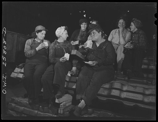 Buffalo, New York. All "hookers" in the processing department of Republic Steel are women. Resting on a pile of billets, they are eating lunch on the job