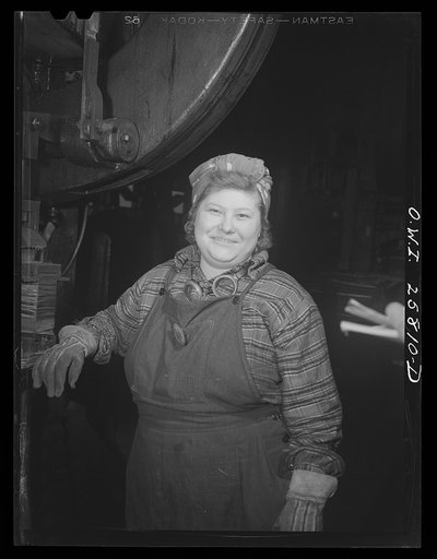 Untitled photo, possibly related to: Buffalo, New York. Esther O'Hara, twenty-six, is a shearman's helper trimming defects from machine gun barrels at Republic Steel. She prefers her job to housework