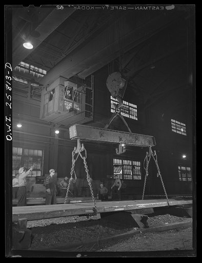 Buffalo, New York. After placing chains around steel bars, "hookers" give signal to the crane operator to hoist in the finishing department of Republic Steel