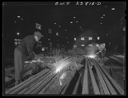 Buffalo, New York. In the finishing department of Republic Steel. Gladys Chase (left), former beautician, using an acetylene torch to burn defects from a twenty-foot steel billet which will later be shaped into a machine gun barrel. It takes six months to learn this process, which is called scarfing