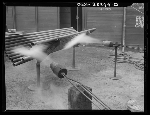 Bethlehem-Fairfield shipyards, Baltimore, Maryland. Testing pipes with flame throwers