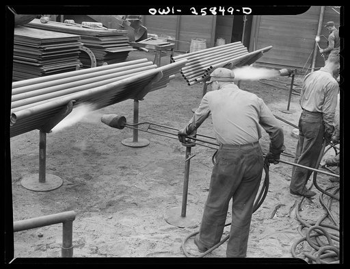 Bethlehem-Fairfield shipyards, Baltimore, Maryland. Heating pipe with a flame thrower