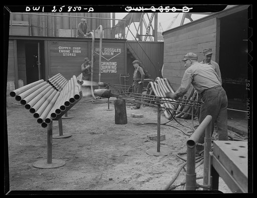 Bethlehem-Fairfield shipyards, Baltimore, Maryland. Heating pipe with a flame thrower