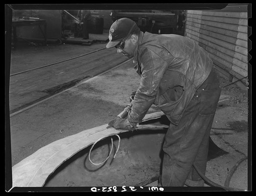 Bethlehem-Fairfield shipyards, Baltimore, Maryland. Trimming copper into proper shape