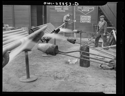 Bethlehem-Fairfield shipyards, Baltimore, Maryland. Heating pipe with a flame thrower