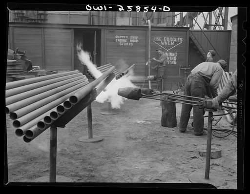 Bethlehem-Fairfield shipyards, Baltimore, Maryland. Heating pipe with a flame thrower