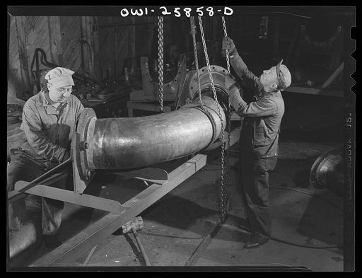 Bethlehem-Fairfield shipyards, Baltimore, Maryland. Fitting a flange on a huge pipe