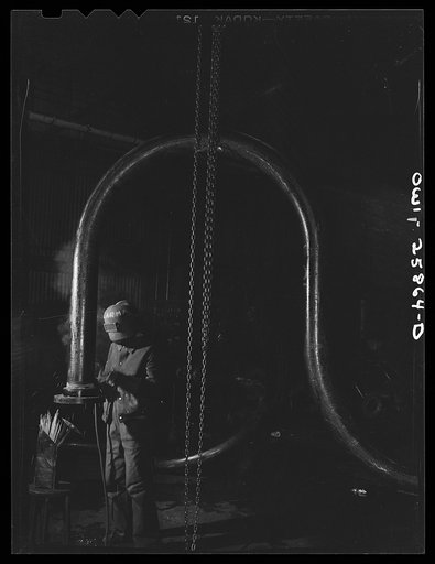 Bethlehem-Fairfield shipyards, Baltimore, Maryland. Woman welder working on bent pipe