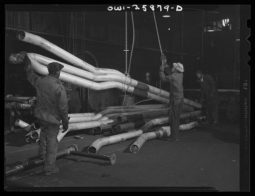 Bethlehem-Fairfield shipyards, Baltimore, Maryland. Lifting pipes with an operated hoist