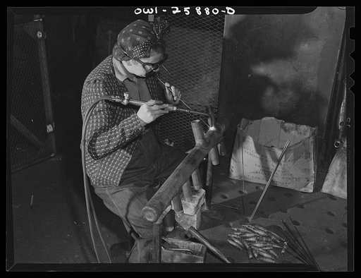 Bethlehem-Fairfield shipyards, Baltimore, Maryland. Woman welder attaching pipe angles