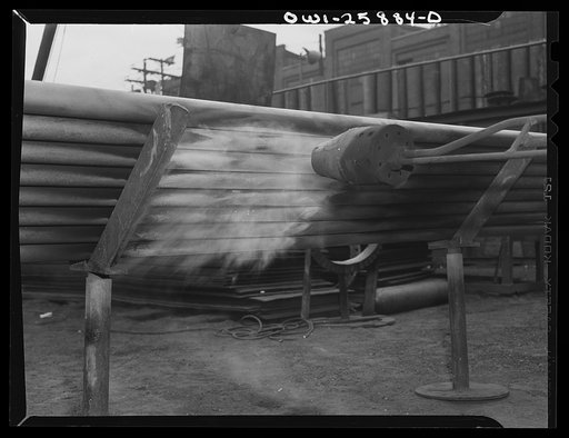 Untitled photo, possibly related to: Bethlehem-Fairfield shipyards, Baltimore, Maryland. Heating pipe with a flame thrower