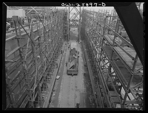 Bethlehem-Fairfield shipyards, Baltimore, Maryland. A freight car between two ways carrying steel sections of ship