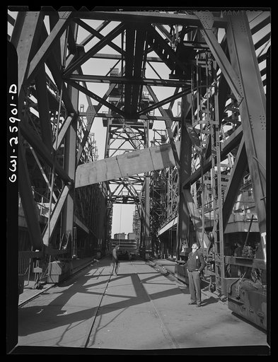 Bethlehem-Fairfield shipyards, Baltimore, Maryland. Hoisting a steel section
