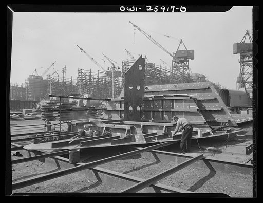 Bethlehem-Fairfield shipyards, Baltimore, Maryland. Working on a ship section with ways in the background