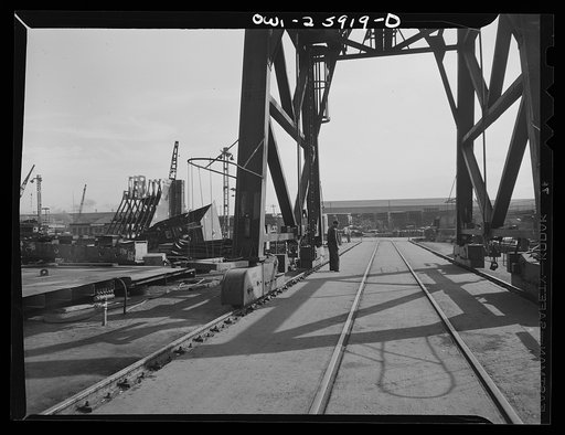 Bethlehem-Fairfield shipyards, Baltimore, Maryland. Safety man at the base of a crane