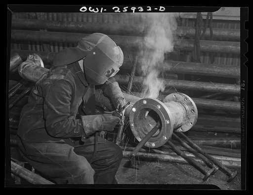 Bethlehem-Fairfield shipyards, Baltimore, Maryland. Welding a flange on a pipe