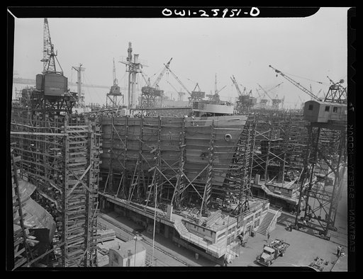 Bethlehem-Fairfield shipyards, Baltimore, Maryland. Painting the sides of a nearly finished ship