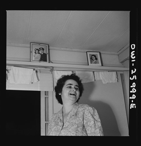 Untitled photo, possibly related to: Arlington, Virginia. An older resident reading the paper and listening to the radio in her room at Idaho Hall, Arlington Farms, a residence for women who work in the U.S. government for the duration of the war