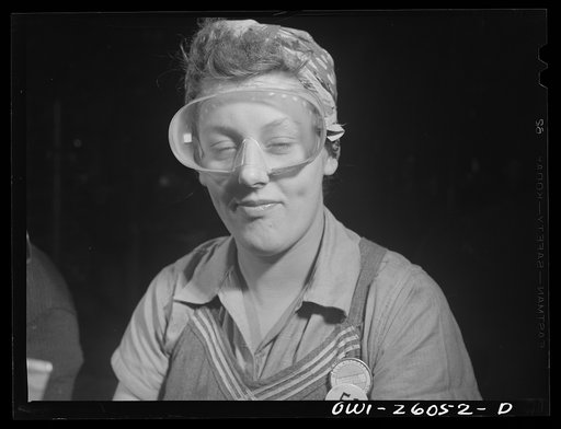Untitled photo, possibly related to: Bell Aircraft Corporation, Niagara Falls, New York. Safety goggles and masks are worn by workers on operations where their eyes might be endangered by metal fragments