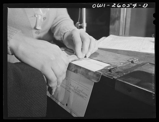 Buffalo, New York. Mabel Goodwin, forty-five, is being fingerprinted at the Bell Aircraft plant. She worked in a factory in the last war; has since been a housewife, and has two children over fourteen