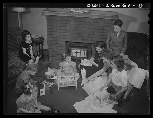 Buffalo, New York. Mrs. Grimm, in the black dress, a twenty-six year old widow, with six children under twelve, is a crane operator at Pratt and Letchworth. Her two youngest children, Mona, two, and Carol, five, live in a foster home during the week. Mrs. Hehr, holding the rabbit, is their foster mo