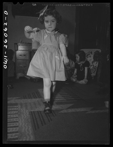 Buffalo, New York. Mrs. Grimm, in the black dress, a twenty-six year old widow, is a crane operator at Pratt and Letchworth. Her two youngest children, Mona, two, and Carol, five, live in a foster home during the week. Their foster mother, Mrs. Hehr, gave Mona a birthday party and invited the other 