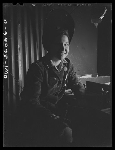 Untitled photo, possibly related to: Bell Aircraft Corporation, Niagara Falls, New York. Woman welder who has been welding the ejection chutes of fifty callibre machine guns