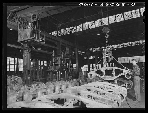 Untitled photo, possibly related to: Buffalo, New York. Symington-Gould, makers of tank, ship, and railroad parts. Woman and man chainman loading rough castings of truck trains for railroad cars on a five-ton crane, also operated by a woman