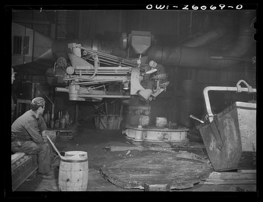Buffalo, New York. Symington-Gould, makers of tank, ship, and railroad parts. Sand slinger operated by a woman. Sand is forced onto pattern with air pressure. The operator wears safety goggles and a dust-proof noseguard to protect herself from ricocheting sand and must rest every twenty minutes or s