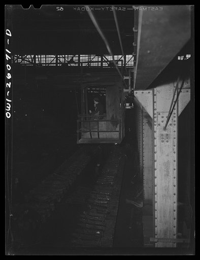Untitled photo, possibly related to: Buffalo, New York. Symington-Gould, makers of tank, ship and railroad parts. Woman operator of a five ton crane picking up rough castings of truck train for railroads. She operated this same crane in the last war; in between was a housewife