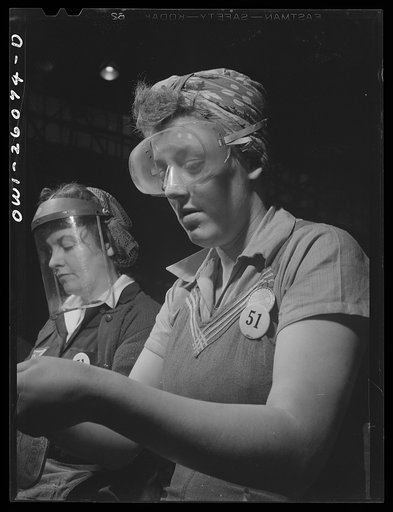 Bell Aircraft Corporation, Niagara Falls, New York. Safety goggles and masks are worn by workers on operations where their eyes might be endangered by metal fragments