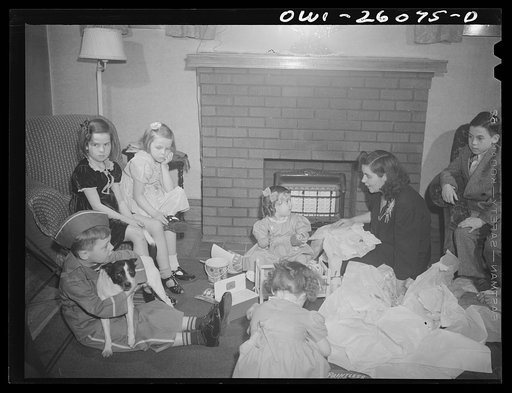 Untitled photo, possibly related to: Buffalo, New York. Mrs. Grimm, a twenty-six year old widow, with six children under twelve, is a crane operator in a war plant. Her two youngest children live in a foster home during the week. Their foster mother, Mrs. Hehr, gave a birthday party for Mona, two