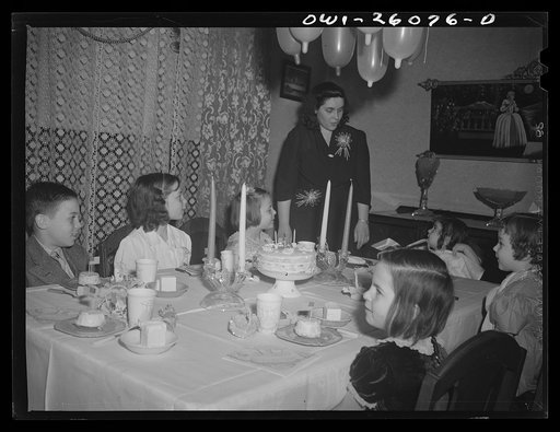 Buffalo, New York. Mrs. Grimm, a twenty-six year old widow, with six children under twelve, is a crane operator in a war plant. Her two youngest children live in a foster home during the week. Their foster mother, Mrs. Hehr, gave a birthday party for Mona, two