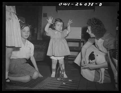 Untitled photo, possibly related to: Buffalo, New York. Mrs. Grimm, a twenty-six year old widow, with six children under twelve, is a crane operator in a war plant. Her two youngest children live in a foster home during the week. Their foster mother, Mrs. Hehr, gave a birthday party for Mona, two