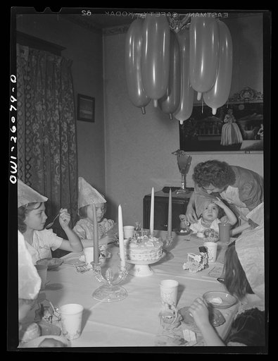 Buffalo, New York. Mrs. Grimm, a twenty-six year old widow, with six children under twelve, is a crane operator in a war plant. Her two youngest children live in a foster home during the week. Their foster mother, Mrs. Hehr, gave a birthday party for Mona, two