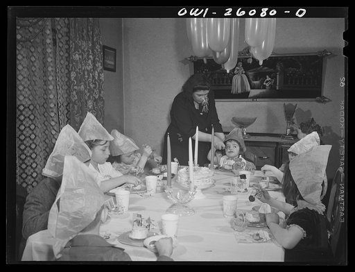 Untitled photo, possibly related to: Buffalo, New York. Mrs. Grimm, a twenty-six year old widow, with six children under twelve, is a crane operator in a war plant. Her two youngest children live in a foster home during the week. Their foster mother, Mrs. Hehr, gave a birthday party for Mona, two