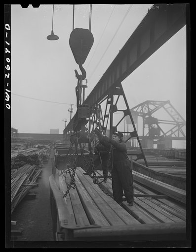 Buffalo, New York. Two "hookers" load a crane from a gondola car in the Republic Steel yard